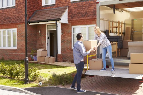 Professional movers carrying household items through a Kingston home