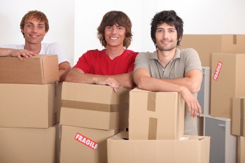 Office desks, chairs, and boxes arranged for a commercial relocation in Kingston